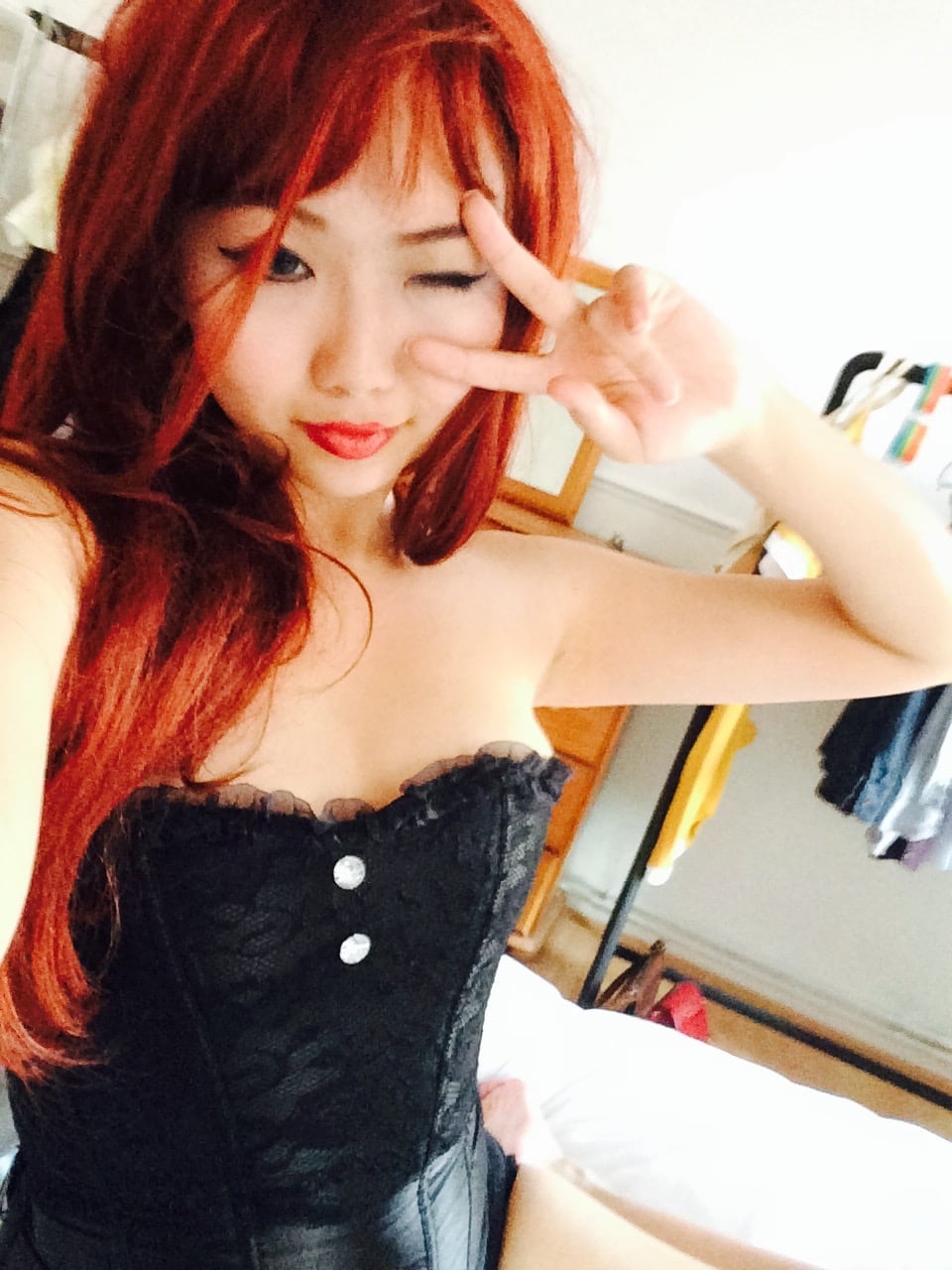 Redhead corset selfie doing peace sign