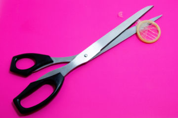 a condom and scissors for making a dental dam